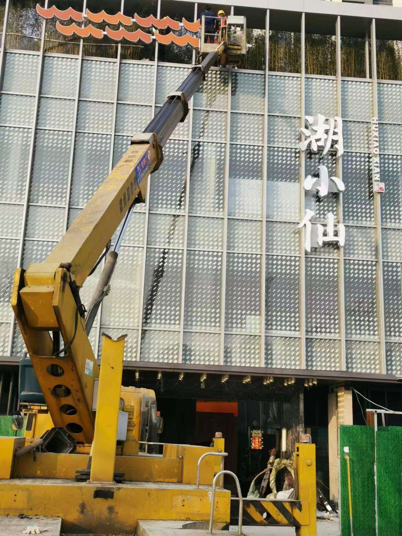 武汉三镇22米带吊篮升降车装玻璃、挂装饰牌施工现场